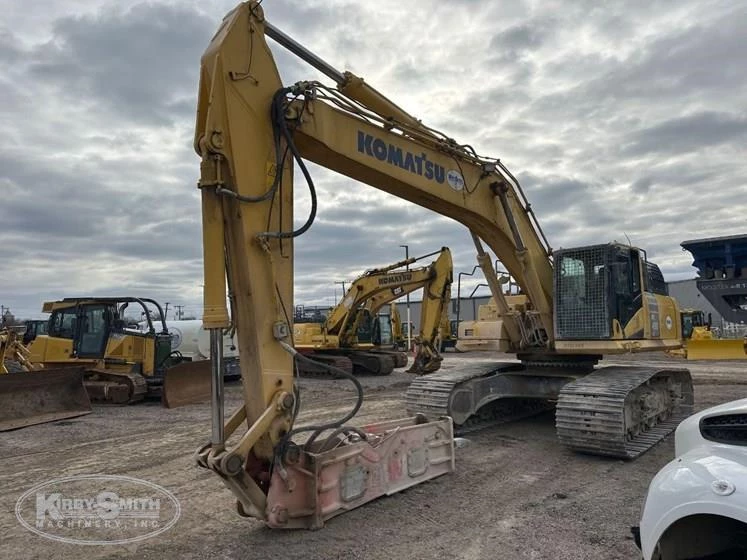 Used Komatsu under cloudy sky